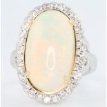 An 18ct white gold oval opal and diamond ring, the centre stone approx. 6.88ct surrounded by