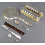 A silver brush set with engine turned decoration comprising hand mirror and 2 clothes brushes, a