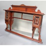 An Edwardian triple plate over mantel mirror contained in a mahogany frame with raised back and