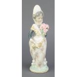 A Lladro figure of a Spanish lady holding a bouquet of flowers 9 1/2", boxedSome of the petals are