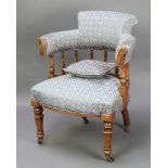 A Victorian oak tub back chair with bobbin turned decoration and upholstered seat and back, raised