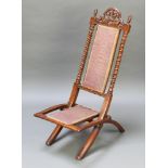 A Victorian mahogany folding chair with spiral turned columns to the sides, pierced cresting rail,