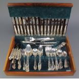 A silver plated canteen of cutlery with fancy handles contained in a fitted case