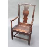 An 18th Century oak Wainscot chair with vase shaped slat back and solid seat and H framed