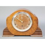 A 1950's 8 day chiming mantel clock with pierced silvered chapter ring and Roman numerals, contained