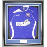 An Ipswich Town Football Club 2011 home football shirt, framed, with numerous players signatures,