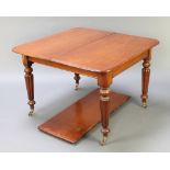 A Victorian mahogany extending dining table with 1 extra leaf, raised on turned and reeded