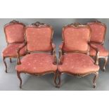 A pair of Continental heavily carved walnut armchairs and a pair of standard chairs with shell