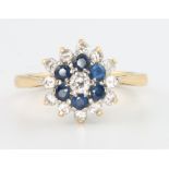 An 18ct yellow gold sapphire and diamond cluster ring, size J 1/2