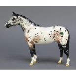 A Beswick figure of a black and white dappled horse 10"