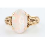 A yellow gold oval opal set dress ring, size Q