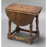 An oak oval drop flap occasional table raised on turned and block supports 18"h x 19"w x 10" when