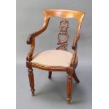 A Victorian mahogany tub back chair with carved and pierced splat back, the seat of serpentine