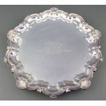 A silver salver with fancy scroll and shell rim and presentation inscription Birmingham 1933, 910