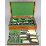 An Edwardian oak canteen containing a set of silver plated cutlery for 6