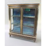 A Victorian ebonised display cabinet with gilt metal mounts and inlay, fitted 3 shelves, raised on