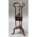 A Georgian style circular mahogany wash stand fitted a bowl receptacle, the base fitted 2 short