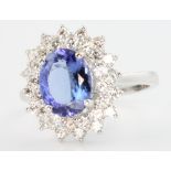 An 18ct white gold tanzanite and diamond oval cluster ring, the centre stone 2.17ct surrounded by 16