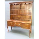 A Georgian style oak dresser the raised back with moulded cornice, shaped apron and fitted 2