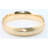 A 14ct yellow gold chased hollow bangle, 22 grams