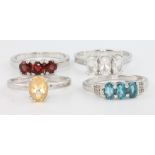 4 silver gem set rings, citrine, topaz, garnet and blue topaz, size N 1/2