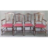 A set of 4 Edwardian mahogany dining chairs with carved cresting rails and pierced vase shaped