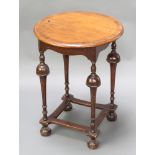 A Queen Anne style circular walnut and crossbanded occasional table, raised on cup and cover