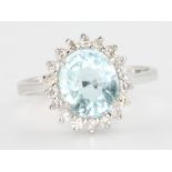 An 18ct white gold oval aquamarine and diamond ring, the centre stone approx. 2.44ct surrounded by