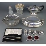 An oval silver plated entree dish and minor plated items