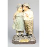 A Continental earthenware group of a boy and girl 12"