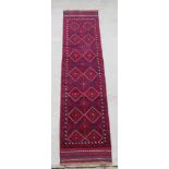 A red and blue Meshwani runner with 14 diamonds to the centre 105" x 24"
