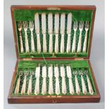 A mahogany canteen containing a set of 12 silver plated fish eaters with chased blades