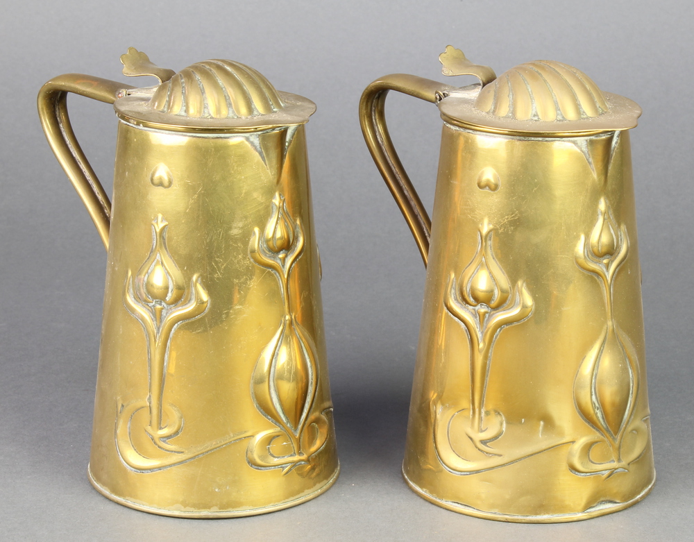 Joseph Sankey & Sons, a pair of Art Nouveau embossed brass lidded jugs of waisted form with stylised