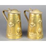 Joseph Sankey & Sons, a pair of Art Nouveau embossed brass lidded jugs of waisted form with stylised