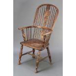 An elm stick and rail back kitchen chair with vase shaped slat back and solid elm seat, raised on