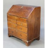 An 18th Century oak bureau, the fall front revealing a stepped fitted interior with well above 2