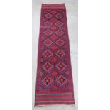 A red and blue ground Meshwani runner with numerous diamonds to the centre 105" x 25"