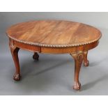 An Edwardian Chippendale style mahogany dining room suite comprising oval extending dining table