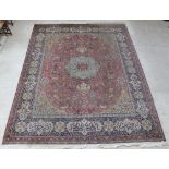 An Axminster brown ground machine made Persian style carpet with central medallion 141" x 109" There