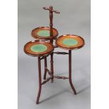 An Edwardian mahogany 3 section cake stand, raised on 3 turned supports with X framed stretcher 30"h