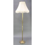 A reeded brass standard lamp, the base with swag decoration