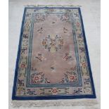 A blue and white ground Chinese rug with floral decoration 91" x 55" There is some staining to