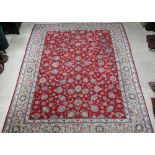A red and white Isfahan carpet with floral ground 161" x 129" The fringe has been cut off on both