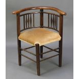 An Edwardian beech framed corner chair with upholstered seat, raised on square tapered supports