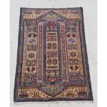 A brown and blue ground Belouche rug with elongated central medallion 56" x 36"