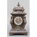 A 19th Century French 8 day striking mantel clock with Roman numerals contained in a bronzed
