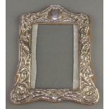 A repousse silver photograph frame with scroll and floral decoration Chester 1918 8" x 6" The