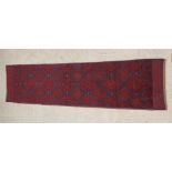 A Meshwani blue and red ground runner with 18 diamonds to the centre 102" x 35"