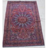 A red and blue ground Persian Dorokhsh rug 62 1/2" x 53", some wear and edges bound