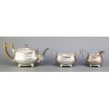 A silver plated tea set with egg and dart rim and fruitwood mounts on ball feet